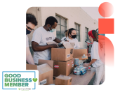 volunteers handing out essential living items with nonprofit hub badge to the left