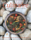 toasted vegetables and herbs in bowl, stone background.